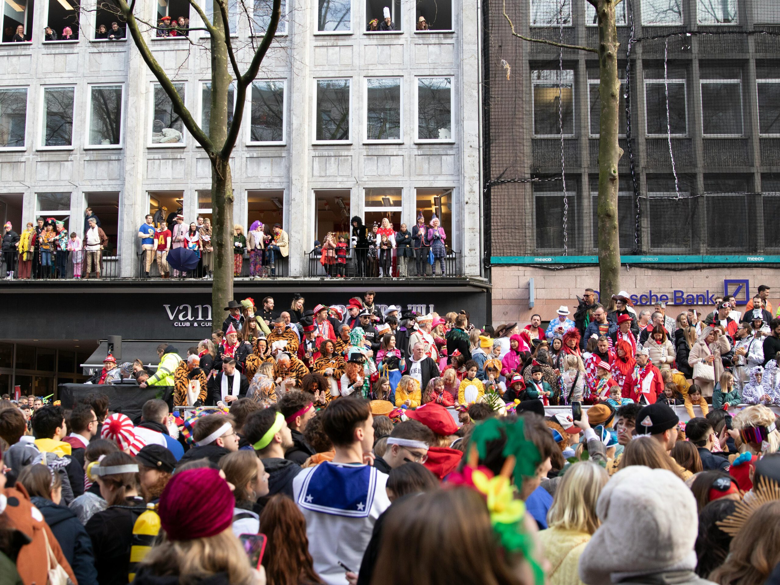 Vibrant carnival parade crowd celebrating in Cologne with costumes and festivities.
